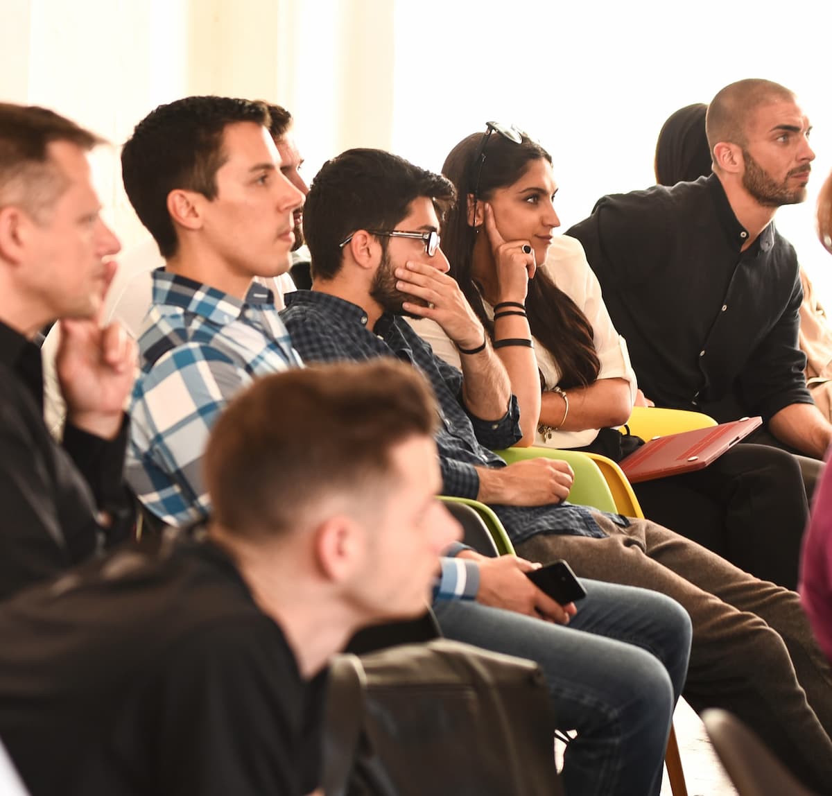 Mixed audience watching keynote speaker webinars